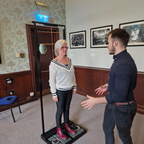Lady being weighed as part of a corporate connections meeting with guest speaker
