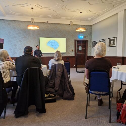 people sat at tables during corporate connections meeting