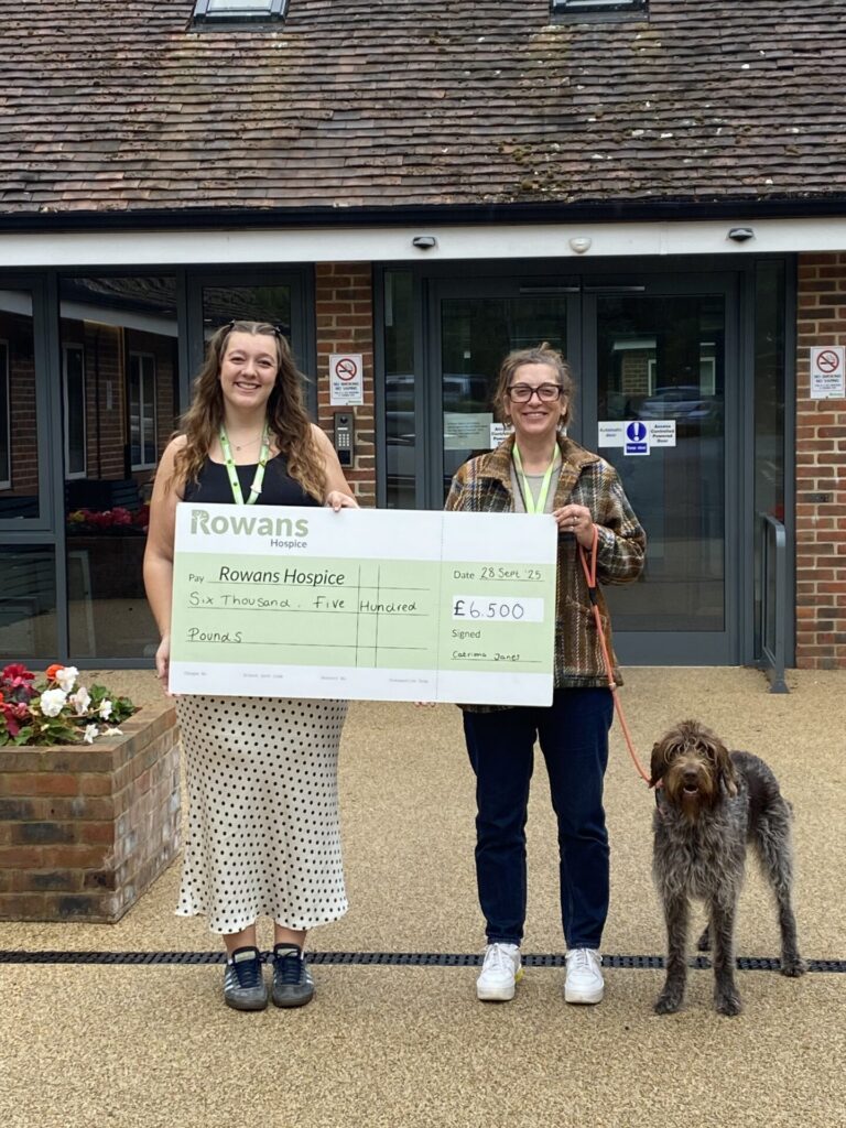 Catriona Janes, her dog, and fundraising team member outside of Rowans Hospice