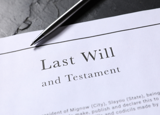 Image of paper with last will and testament, black and white, with black pen over.